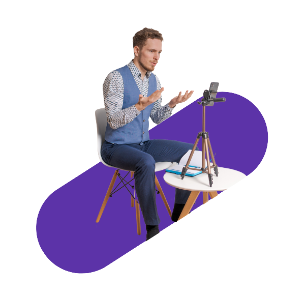 man sitting on a chair speaking in front of his phone mounted on a tripod