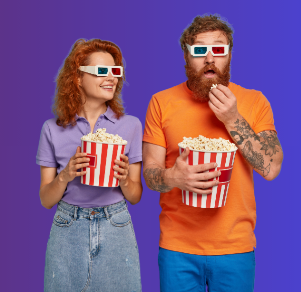 man and woman wearing 3D glasses eating popcorn on purple background